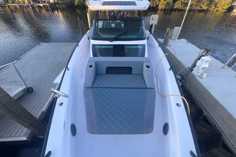 Axopar 37 Suntop Yacht Photos Pics 2024 Axopar 37 SunTop boat docked, featuring spacious deck and seating area.