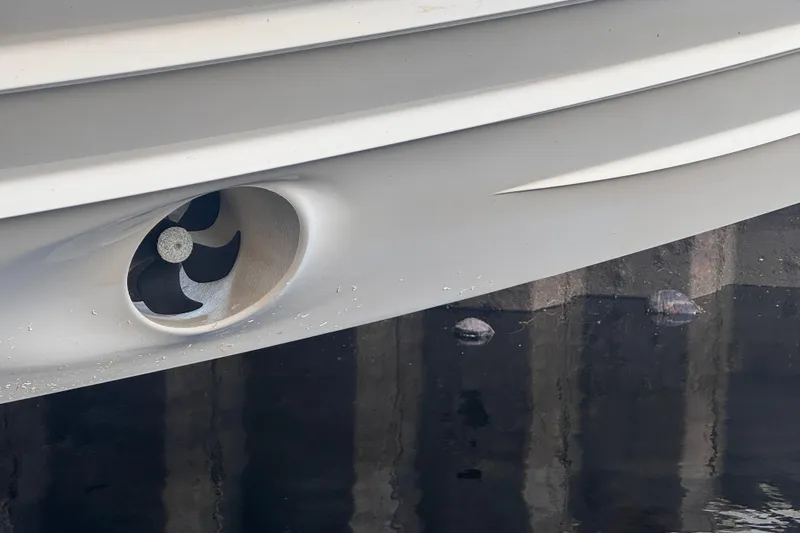 Axopar 37 Suntop Yacht Photos Pics Close-up of 2024 Axopar 37 SunTop boat hull with visible propeller.