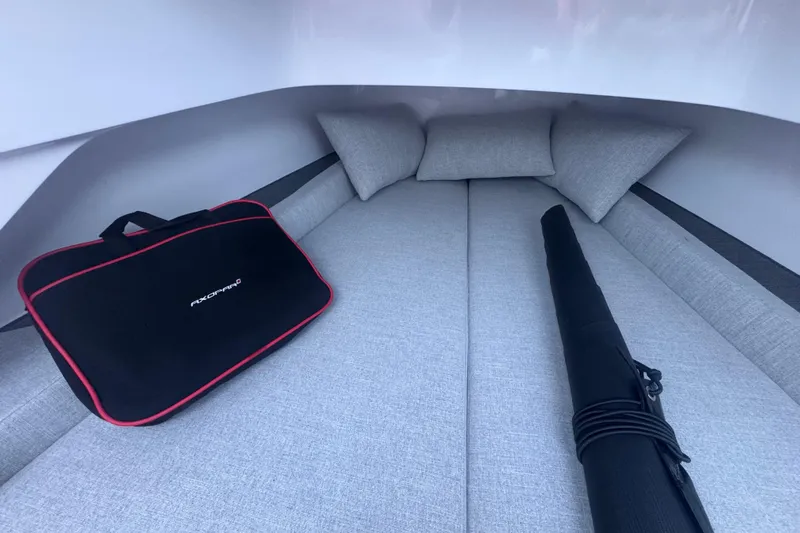 Axopar 37 Suntop Yacht Photos Pics 2024 Axopar 37 SunTop cabin interior with cushions and branded bag.