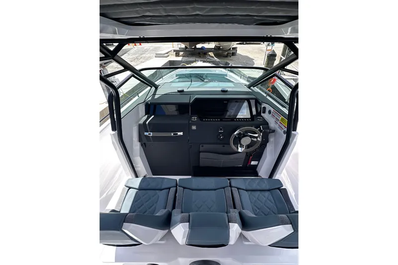Axopar 37 Suntop Yacht Photos Pics 2024 Axopar 37 SunTop boat interior with modern dashboard and seating.