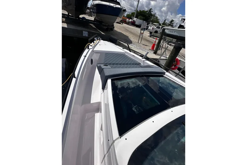 Axopar 37 Suntop Yacht Photos Pics 2024 Axopar 37 SunTop boat docked, showcasing sleek design and modern features.