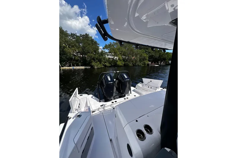 Axopar 37 Suntop Yacht Photos Pics 2024 Axopar 37 SunTop boat with dual engines on a serene waterway.