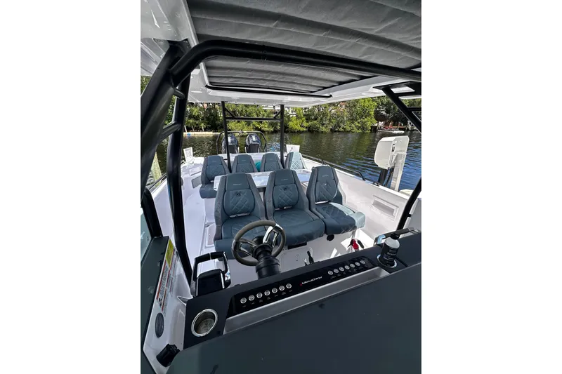 Axopar 37 Suntop Yacht Photos Pics 2024 Axopar 37 SunTop boat interior with modern seating and steering console.