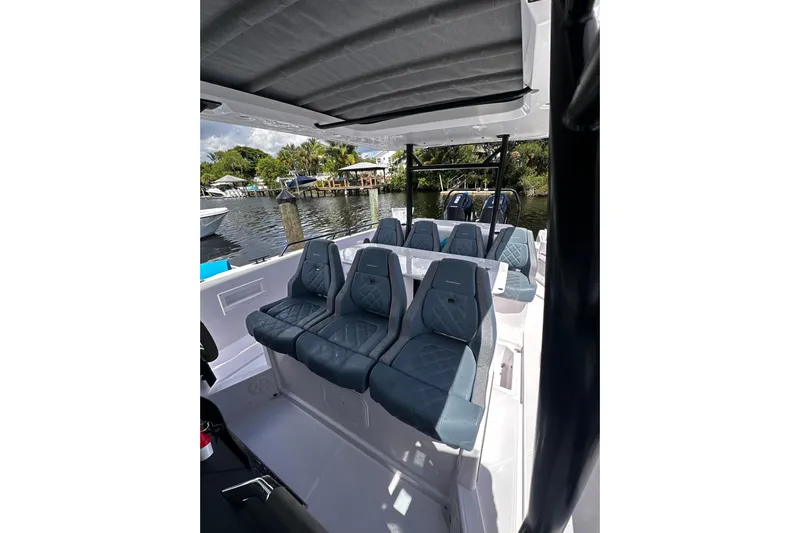 Axopar 37 Suntop Yacht Photos Pics 2024 Axopar 37 SunTop boat interior with stylish seating and canopy.