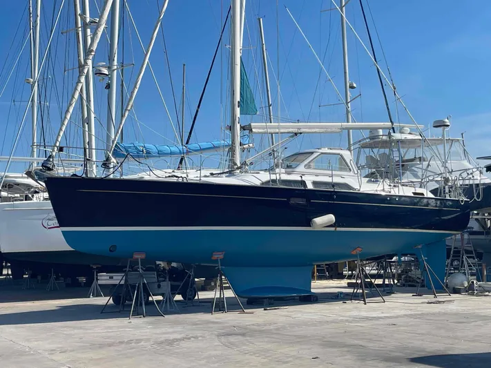Gratitude Yacht Photos Pics Sailboat Moody 46 CC 1999 on dry dock, blue hull, clear sky background.
