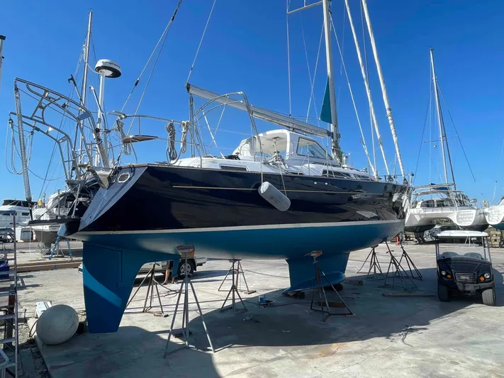 Gratitude Yacht Photos Pics Sailboat Moody 46 CC 1999 on dry dock, blue hull, clear sky background.