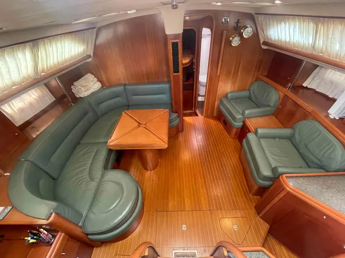 Gratitude Yacht Photos Pics Luxurious 1999 Moody 46 CC yacht interior with green leather seating and wooden finishes.