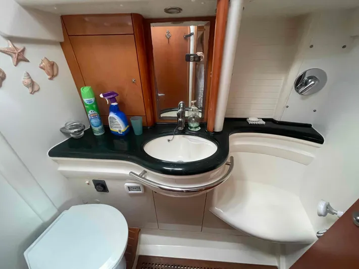 Gratitude Yacht Photos Pics Bathroom interior of a 1999 Moody 46 CC yacht, featuring a sink and toilet.