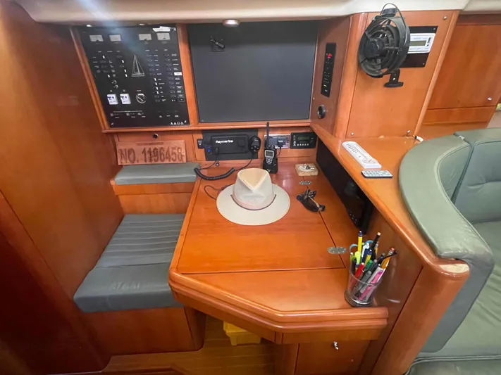 Gratitude Yacht Photos Pics Navigation station in a 1999 Moody 46 CC yacht with control panels and seating.