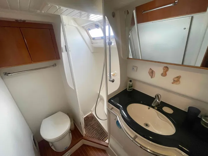 Gratitude Yacht Photos Pics Bathroom interior of 1999 Moody 46 CC yacht with shower, sink, and toilet.