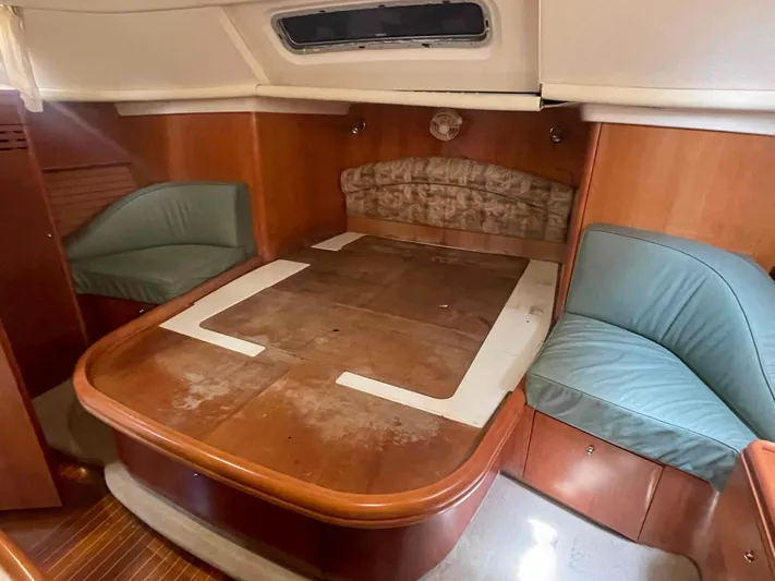 Gratitude Yacht Photos Pics Cozy cabin interior of 1999 Moody 46 CC sailboat with wooden furnishings and seating.