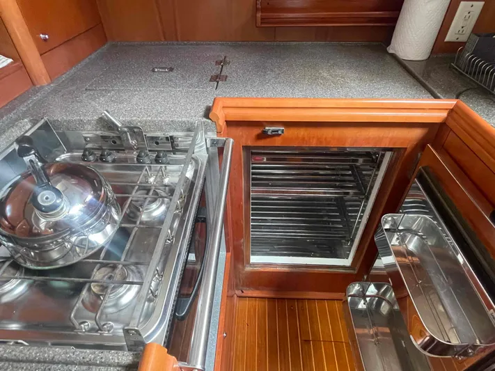 Gratitude Yacht Photos Pics Galley kitchen in 1999 Moody 46 CC yacht with stove and fridge.