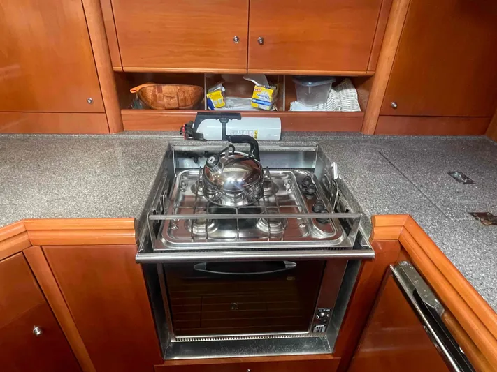 Gratitude Yacht Photos Pics Galley kitchen in 1999 Moody 46 CC yacht with stove and kettle.