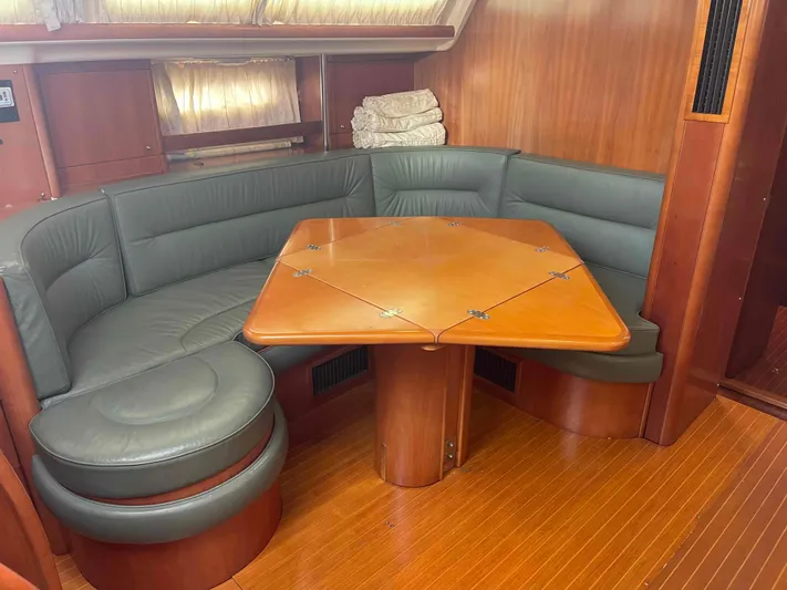 Gratitude Yacht Photos Pics Cozy dining area in 1999 Moody 46 CC yacht with wooden table and cushioned seating.