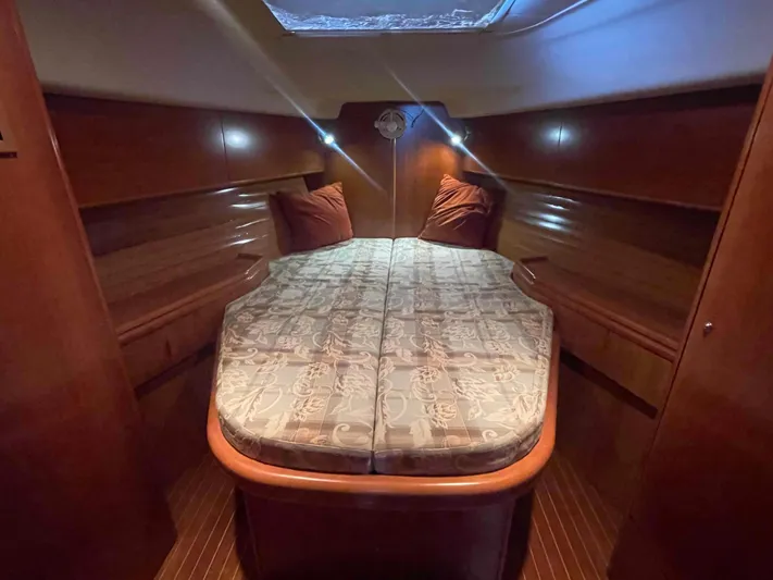 Gratitude Yacht Photos Pics Cozy cabin interior of 1999 Moody 46 CC yacht with wooden finish and double bed.