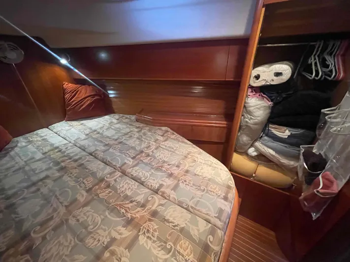 Gratitude Yacht Photos Pics Cozy cabin interior of 1999 Moody 46 CC yacht with bed and storage.