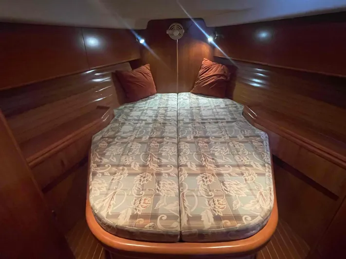 Gratitude Yacht Photos Pics Cozy cabin interior of 1999 Moody 46 CC yacht with double bed and wooden finish.