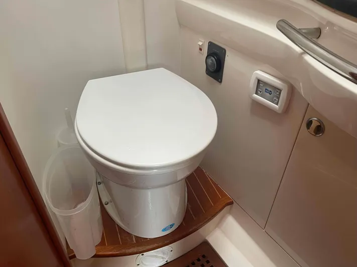 Gratitude Yacht Photos Pics Toilet in 1999 Moody 46 CC yacht bathroom with wooden flooring and control panel.