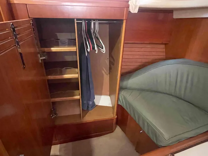 Gratitude Yacht Photos Pics Wooden wardrobe and seating area inside a 1999 Moody 46 CC yacht cabin.