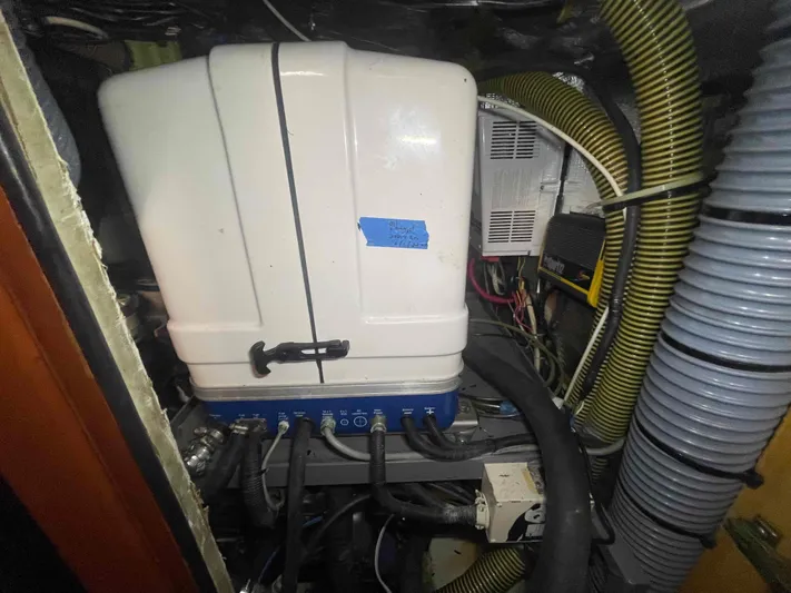 Gratitude Yacht Photos Pics Engine compartment of a 1999 Moody 46 CC sailboat with various hoses and equipment.