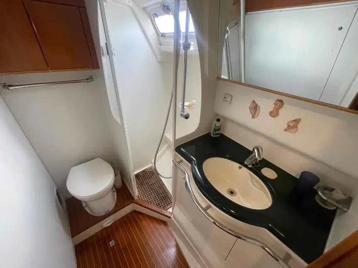 Gratitude Yacht Photos Pics Bathroom interior of 1999 Moody 46 CC yacht with shower, sink, and toilet.