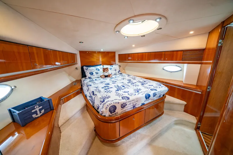 Island Girl Yacht Photos Pics Luxurious cabin interior of 2002 Sunseeker Predator 68 yacht with elegant wood finish.