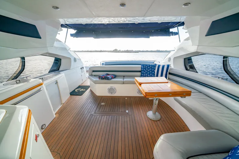 Island Girl Yacht Photos Pics Luxurious Sunseeker Predator 68 yacht interior, featuring elegant seating and a wooden table, 2002 model.