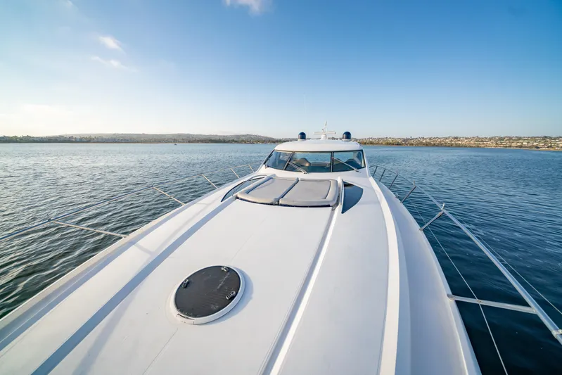 Island Girl Yacht Photos Pics Sunseeker Predator 68 yacht cruising on calm waters under clear blue sky.
