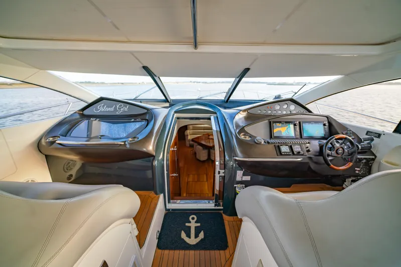 Island Girl Yacht Photos Pics Interior view of 2002 Sunseeker Predator 68 yacht cockpit with modern controls and seating.