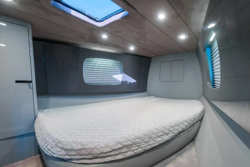  Yacht Photos Pics Luxurious interior cabin of a 2003 Magnum 44 yacht with modern lighting and bedding.