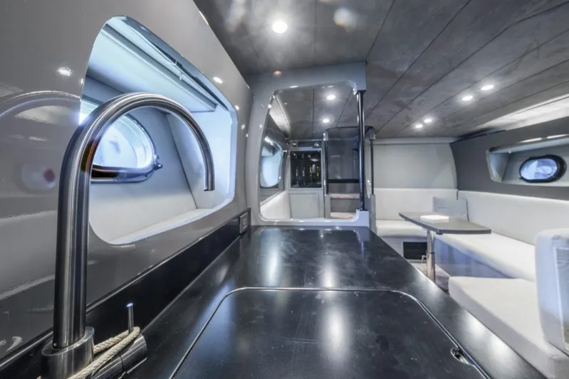  Yacht Photos Pics Luxurious interior of a 2003 Magnum 44 yacht with modern kitchen and seating area.