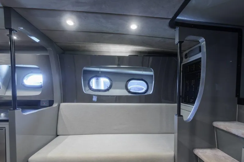  Yacht Photos Pics Interior of a 2003 Magnum 44 boat with modern seating and porthole windows.