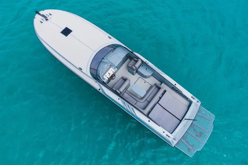  Yacht Photos Pics Aerial view of 2003 Magnum 44 boat on clear turquoise water.