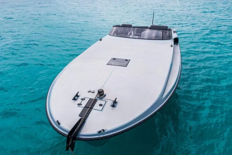  Yacht Photos Pics Sleek 2003 Magnum 44 boat on clear turquoise water.