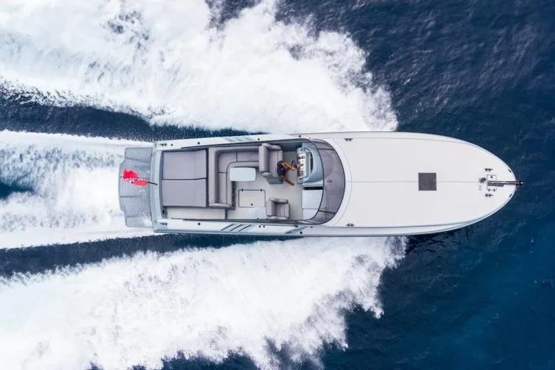  Yacht Photos Pics Aerial view of a 2003 Magnum 44 speedboat cruising on open water.