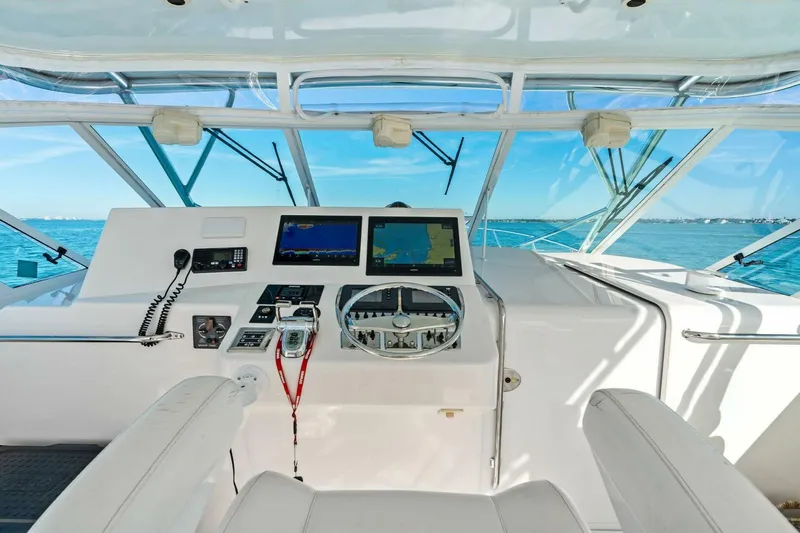 Miss B Havin Yacht Photos Pics Helm of 2005 Cabo 40 Express boat with navigation screens and ocean view.