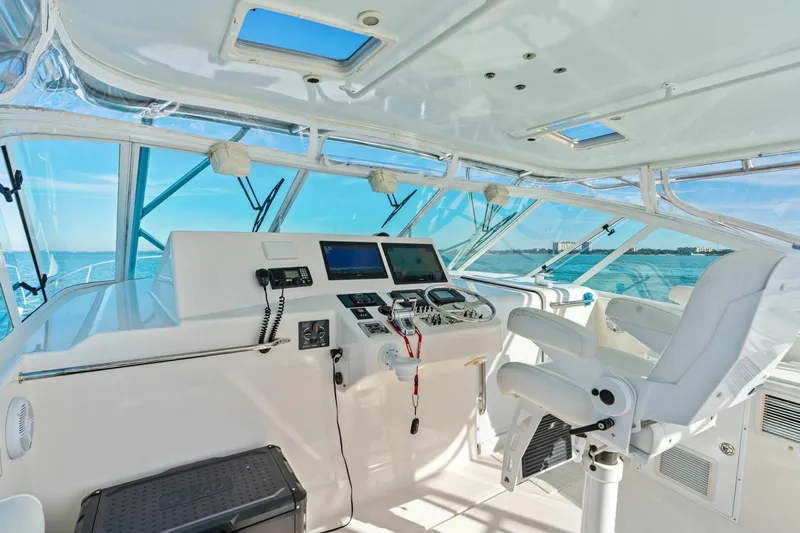 Miss B Havin Yacht Photos Pics 2005 Cabo 40 Express helm with modern navigation equipment and ocean view.