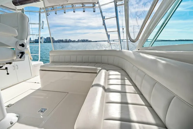 Miss B Havin Yacht Photos Pics Luxurious interior of 2005 Cabo 40 Express yacht with white seating and ocean view.