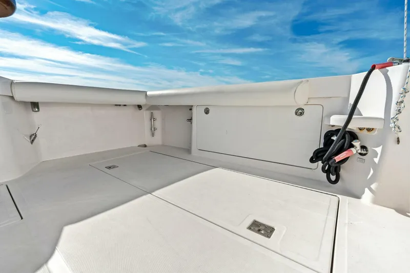 Miss B Havin Yacht Photos Pics 2005 Cabo 40 Express boat deck with storage compartments and coiled ropes under blue sky.