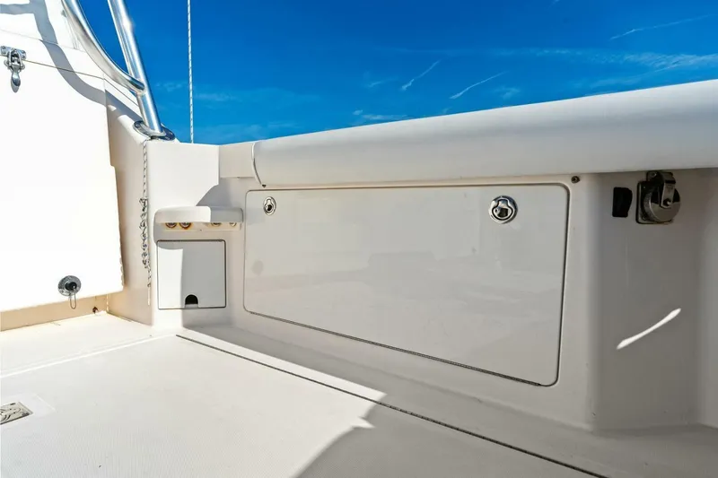 Miss B Havin Yacht Photos Pics 2005 Cabo 40 Express boat deck with storage compartment under clear blue sky.