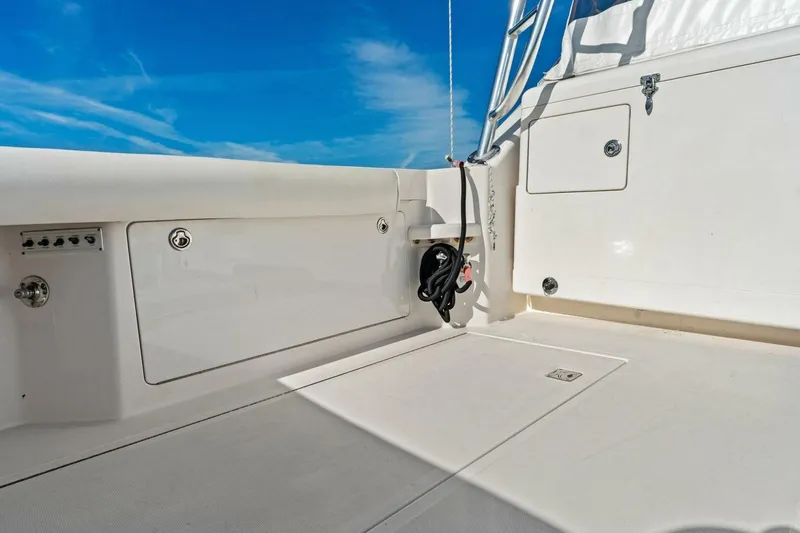 Miss B Havin Yacht Photos Pics 2005 Cabo 40 Express boat deck with storage compartments under clear blue sky.