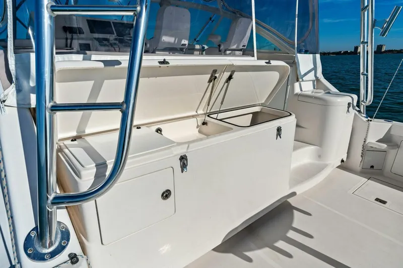 Miss B Havin Yacht Photos Pics 2005 Cabo 40 Express boat deck with open storage compartments and ladder.