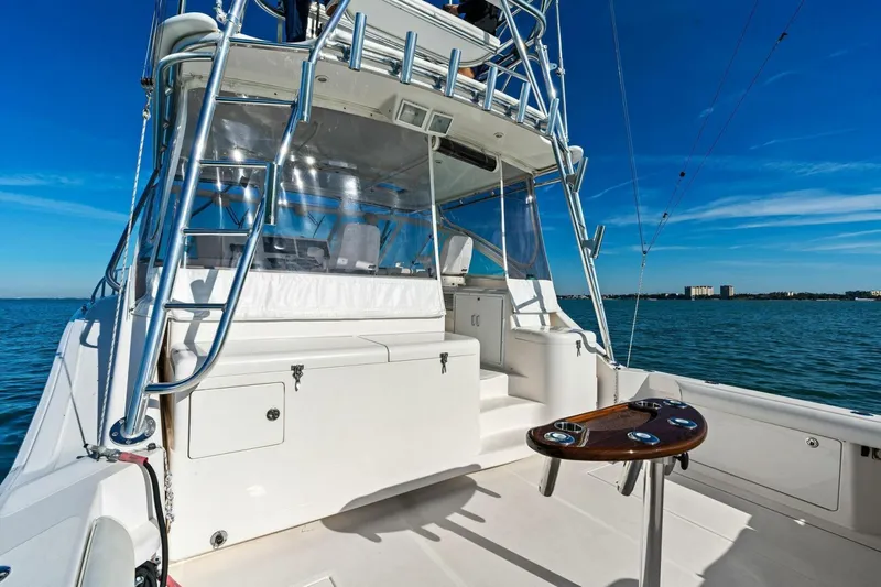 Miss B Havin Yacht Photos Pics 2005 Cabo 40 Express yacht with sleek design on open water.