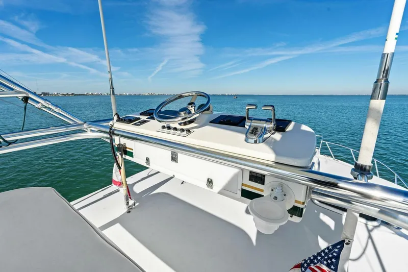 Miss B Havin Yacht Photos Pics 2005 Cabo 40 Express yacht helm with ocean view and clear blue sky.