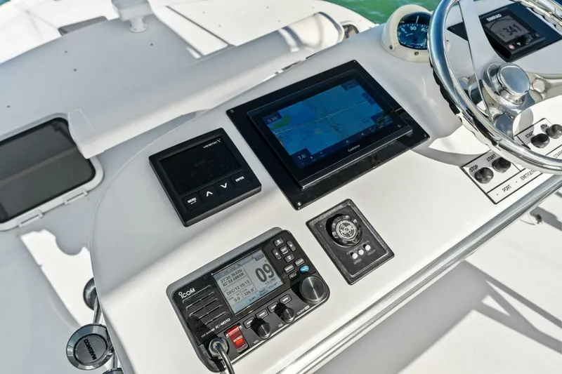 Miss B Havin Yacht Photos Pics Control panel of a 2005 Cabo 40 Express boat with navigation and communication equipment.
