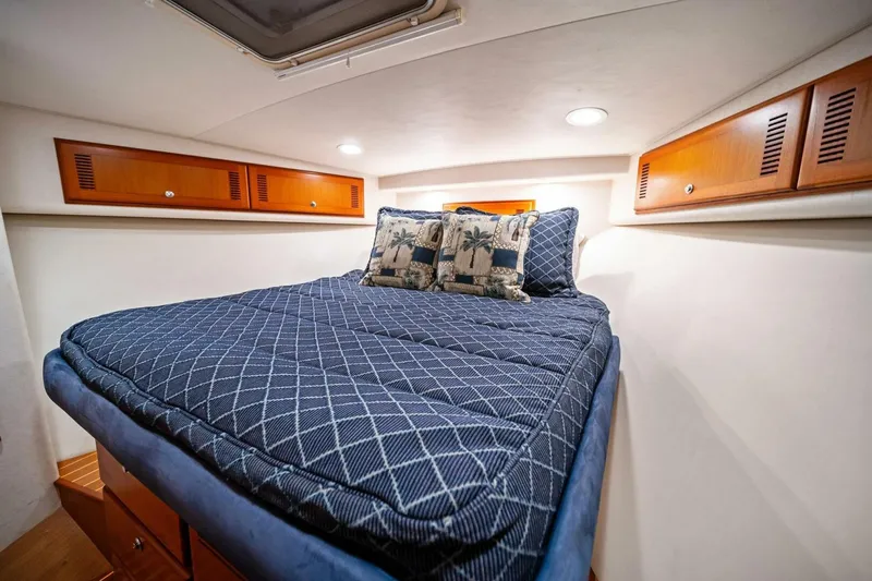 Miss B Havin Yacht Photos Pics Luxurious cabin interior of 2005 Cabo 40 Express yacht with cozy bedding.