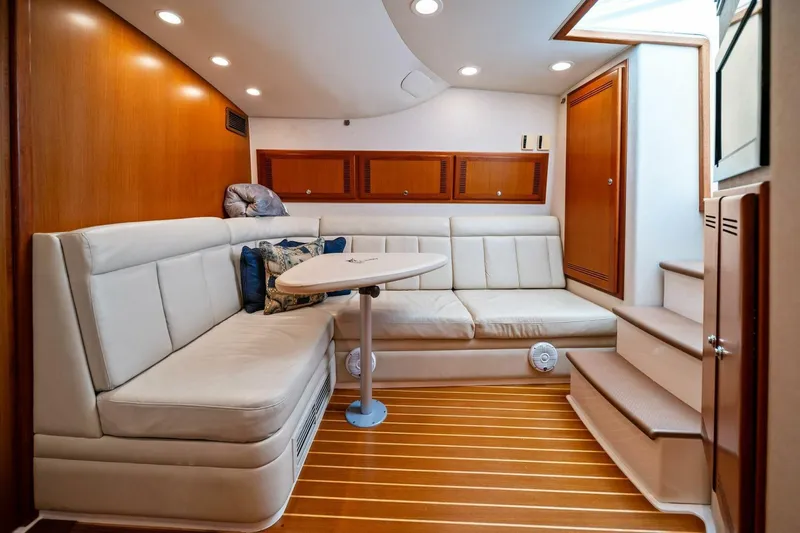 Miss B Havin Yacht Photos Pics Luxurious interior of 2005 Cabo 40 Express yacht with plush seating and wooden accents.