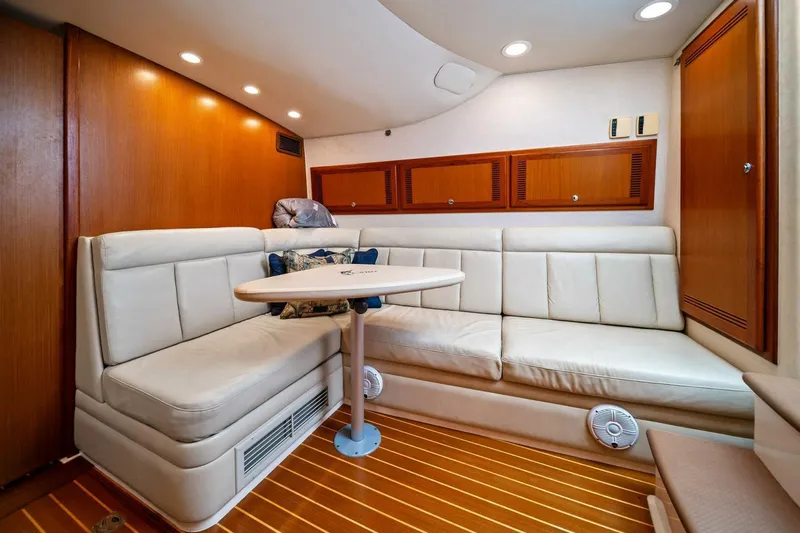Miss B Havin Yacht Photos Pics Luxurious interior of 2005 Cabo 40 Express yacht with plush seating and wooden accents.