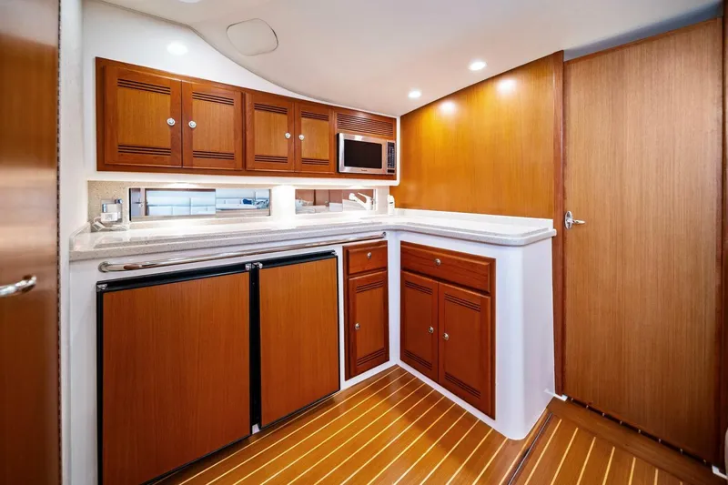 Miss B Havin Yacht Photos Pics Luxurious 2005 Cabo 40 Express yacht interior with wooden cabinetry and modern amenities.
