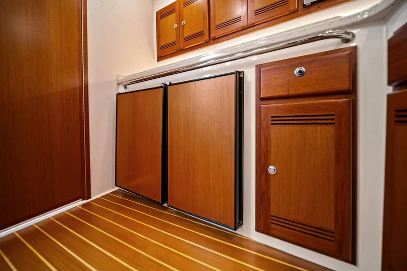 Miss B Havin Yacht Photos Pics 2005 Cabo 40 Express interior with wooden cabinets and flooring.